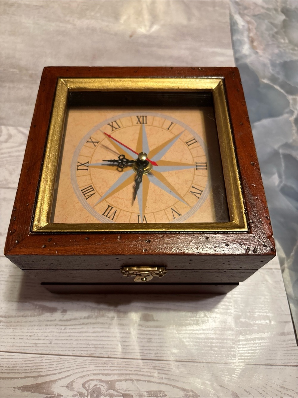 Brown Wooden Compass-Style Wall Clock with Gold Trim